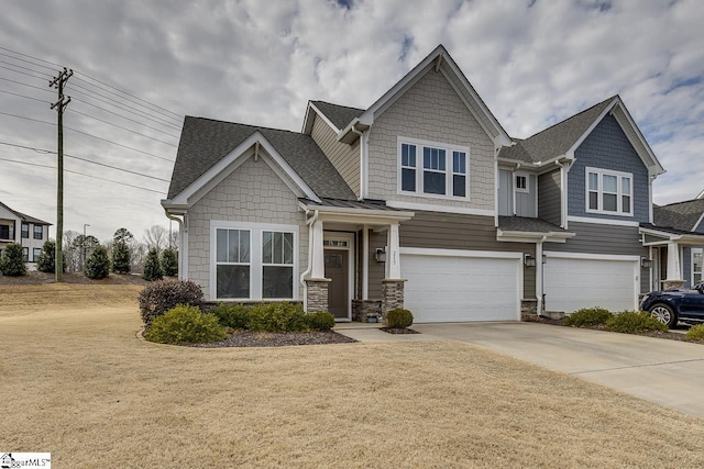 craftsman-style home with a garage and a front yard