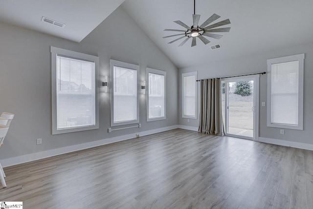 spare room with ceiling fan, lofted ceiling, and light hardwood / wood-style flooring