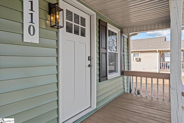 view of exterior entry with a porch