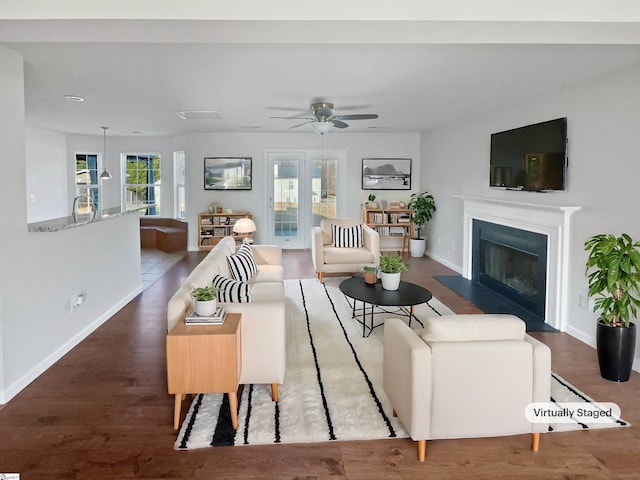 living room featuring ceiling fan, wood-type flooring, and a wealth of natural light