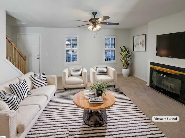 living room with ceiling fan and carpet flooring