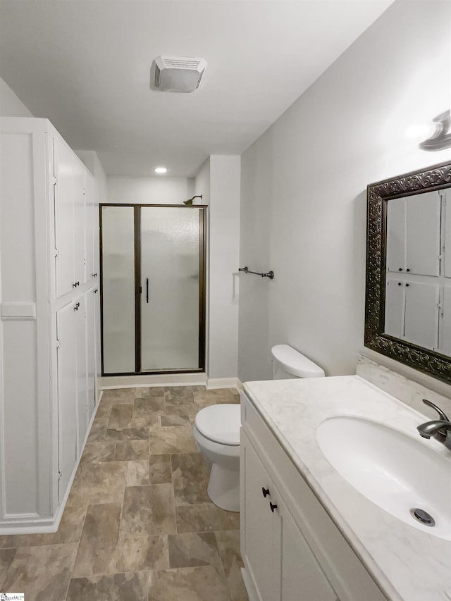 bathroom featuring walk in shower, vanity, and toilet