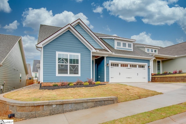 craftsman-style house with a garage and a front lawn