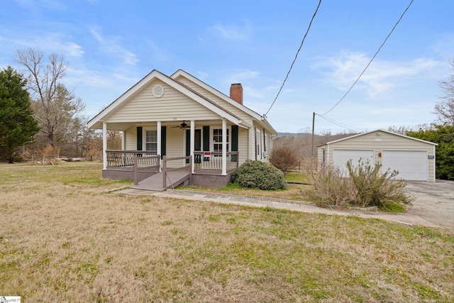 bungalow with a garage, an outbuilding, covered porch, and a front lawn