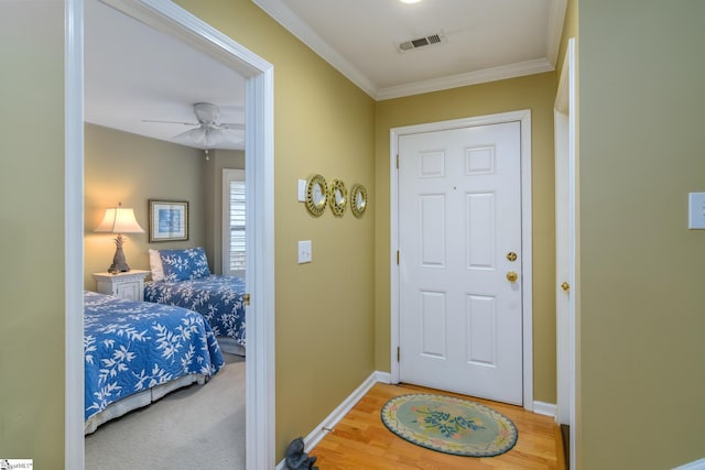 interior space with hardwood / wood-style flooring, ornamental molding, and ceiling fan