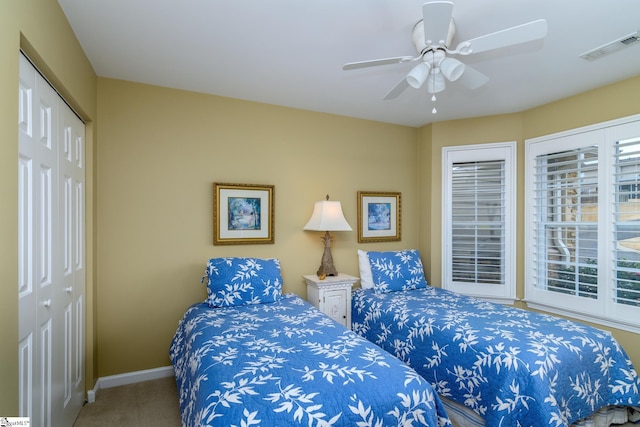 bedroom featuring ceiling fan, carpet floors, and a closet