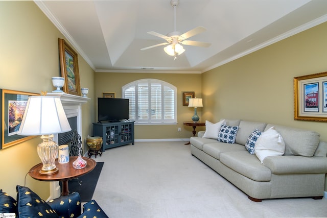 carpeted living room featuring a tray ceiling, crown molding, and ceiling fan