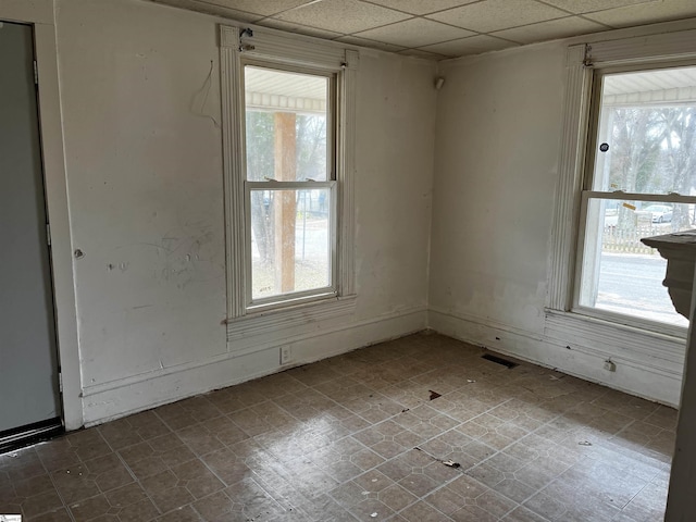 spare room featuring a paneled ceiling