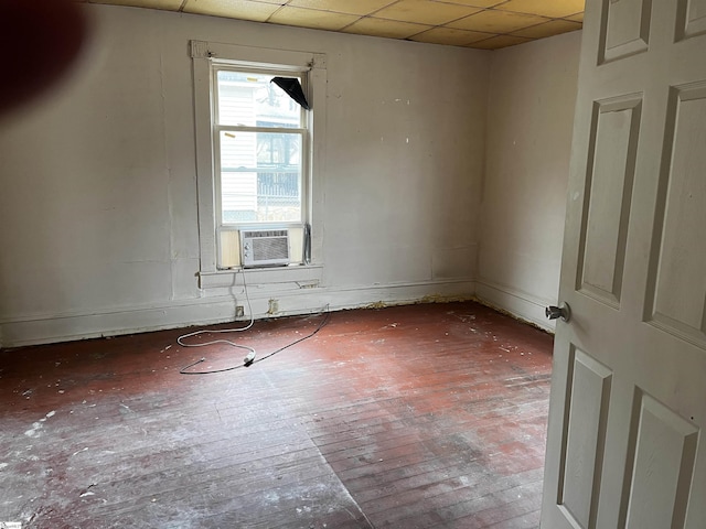 spare room with a paneled ceiling and cooling unit