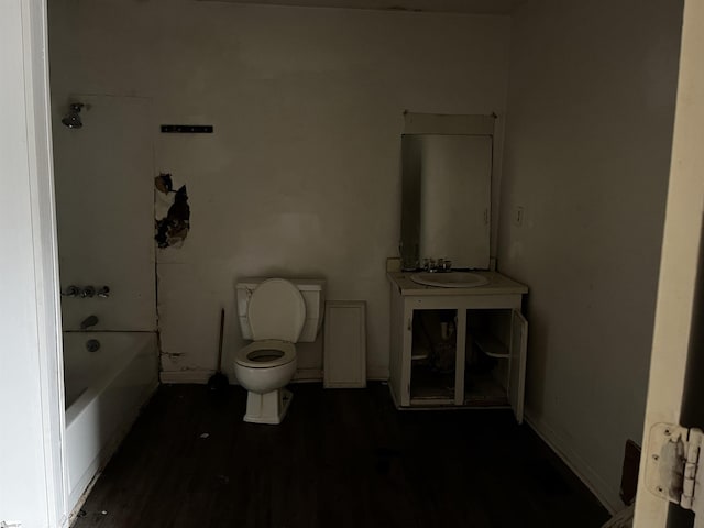 bathroom featuring sink, a bath, and toilet