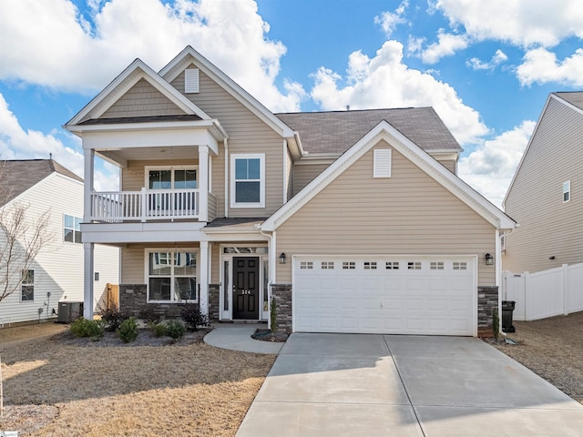 craftsman house featuring central AC unit, a garage, and a balcony