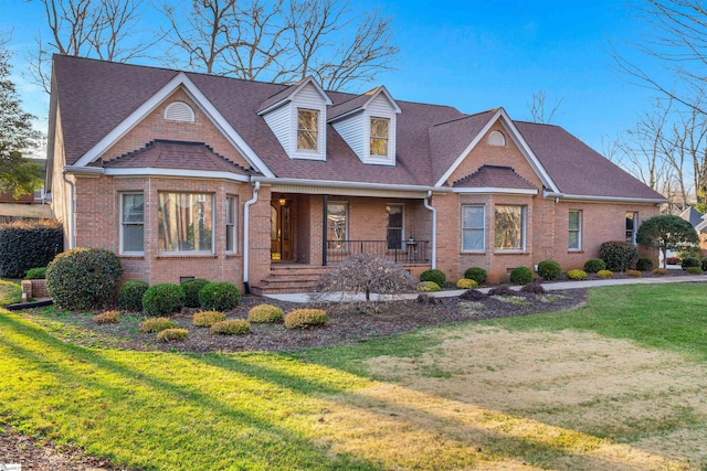 view of front of house with a porch and a front yard