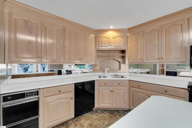 kitchen with sink, black dishwasher, light brown cabinets, and wall oven