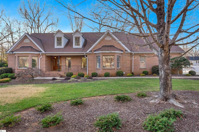 view of front of home with a front yard and a porch