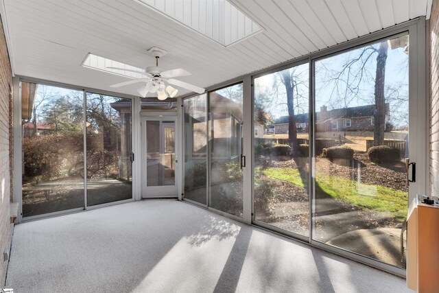 sunroom featuring ceiling fan