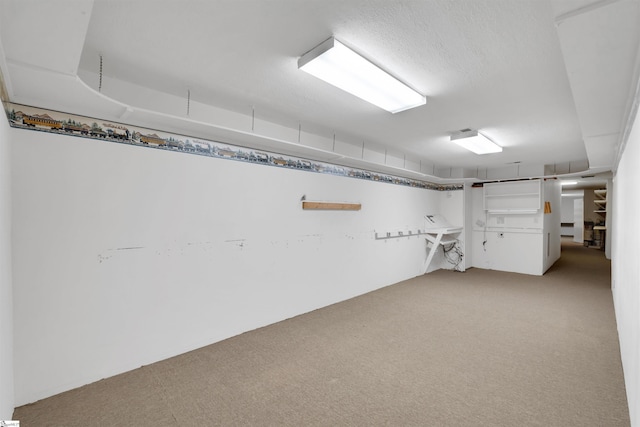 basement with light colored carpet and a textured ceiling