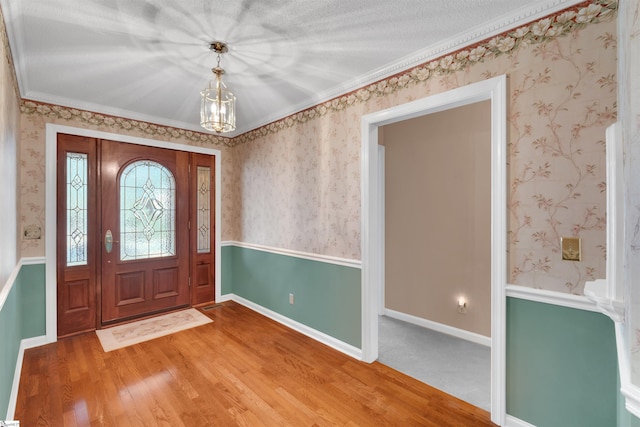 entryway with an inviting chandelier and wood-type flooring