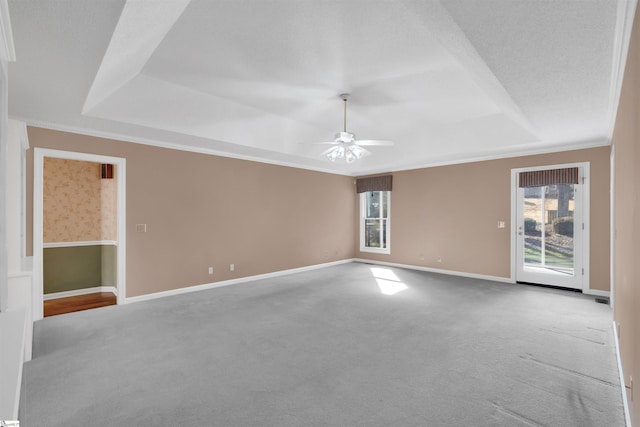 spare room with crown molding, light colored carpet, ceiling fan, and a tray ceiling
