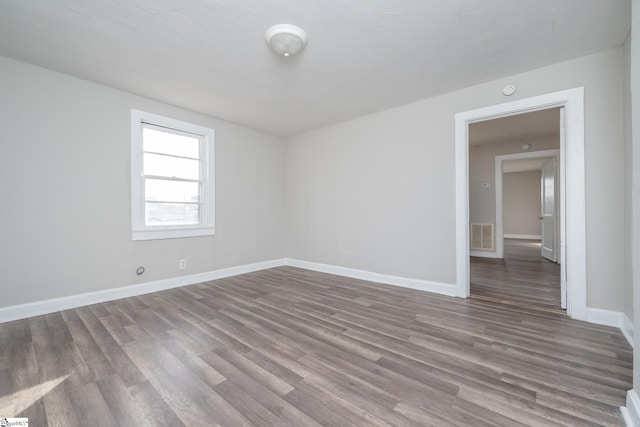 spare room featuring hardwood / wood-style floors