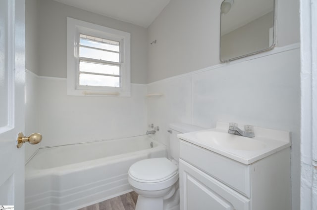 full bathroom with hardwood / wood-style floors, vanity, bathing tub / shower combination, and toilet