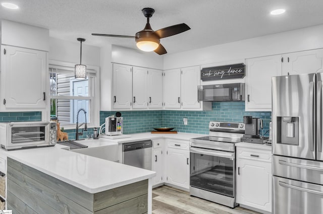 kitchen featuring white cabinetry, stainless steel appliances, and sink