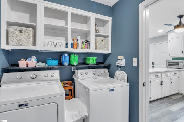 laundry room featuring ceiling fan, light hardwood / wood-style floors, and washing machine and clothes dryer