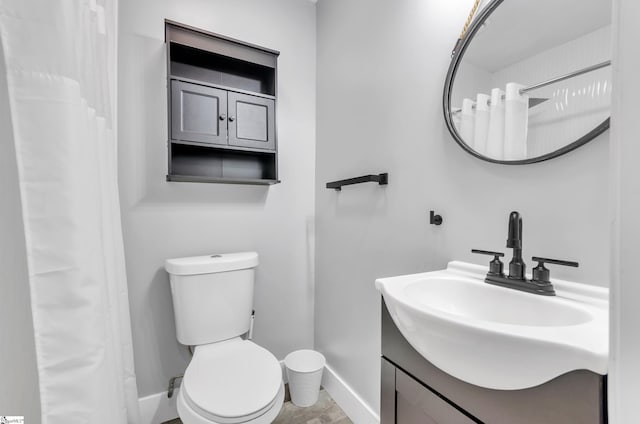 bathroom with vanity, a shower with shower curtain, and toilet