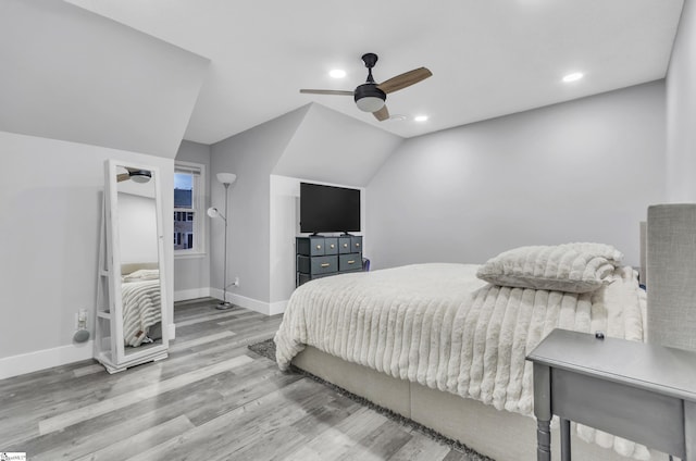 bedroom with vaulted ceiling, ceiling fan, and light hardwood / wood-style flooring