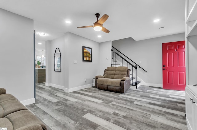 living room featuring ceiling fan and light wood-type flooring