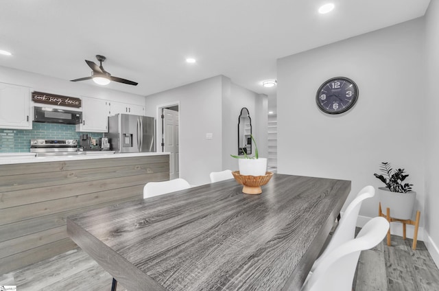 dining space featuring ceiling fan and light hardwood / wood-style flooring