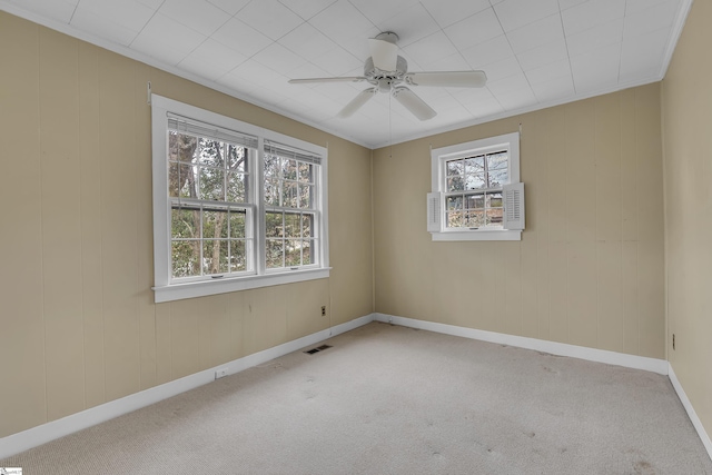 spare room with ornamental molding, light colored carpet, and ceiling fan