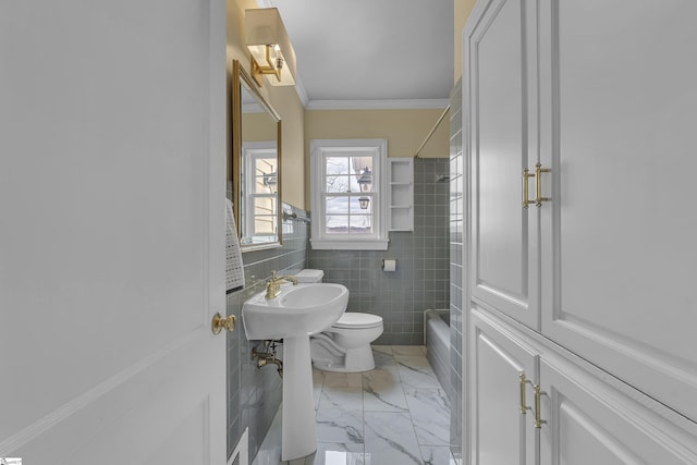 bathroom with ornamental molding, toilet, tile walls, and shower / tub combination