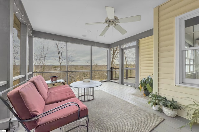 sunroom featuring ceiling fan