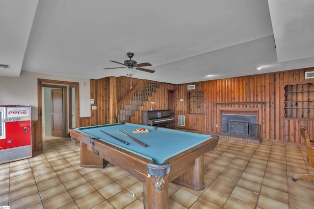 rec room with wooden walls, billiards, ceiling fan, and light tile patterned flooring