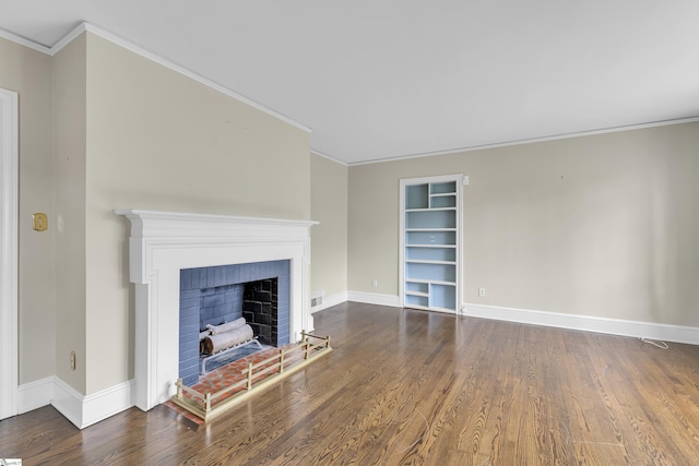 unfurnished living room with dark hardwood / wood-style flooring, built in shelves, a fireplace, and ornamental molding