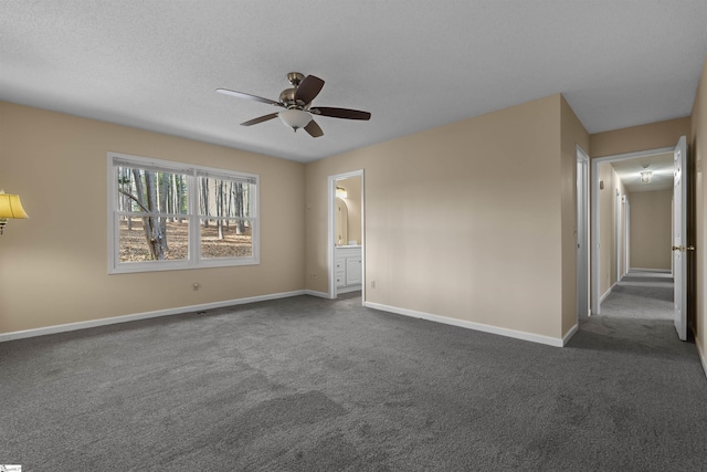 spare room with dark carpet, a textured ceiling, and ceiling fan