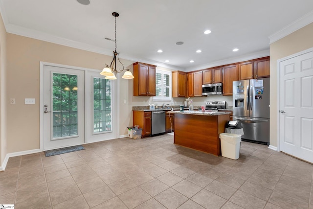 kitchen with light stone counters, crown molding, a center island, hanging light fixtures, and stainless steel appliances