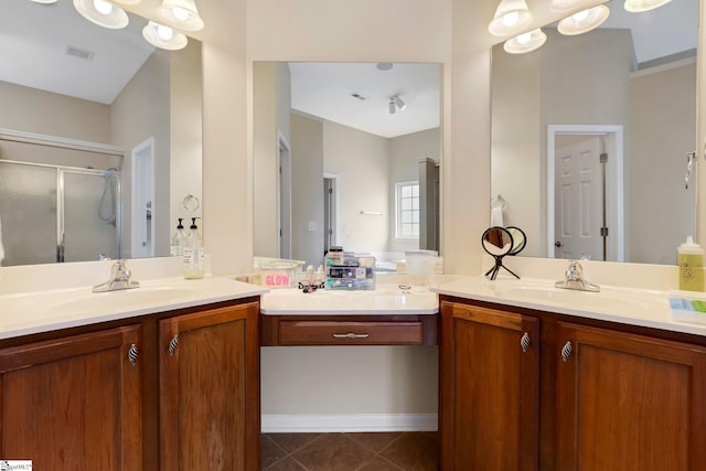 bathroom featuring tile patterned flooring, vanity, and walk in shower