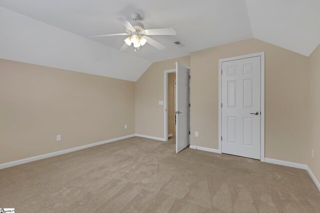 additional living space with ceiling fan, light colored carpet, and lofted ceiling