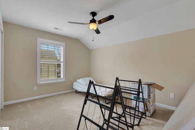 interior space featuring lofted ceiling, light colored carpet, and ceiling fan