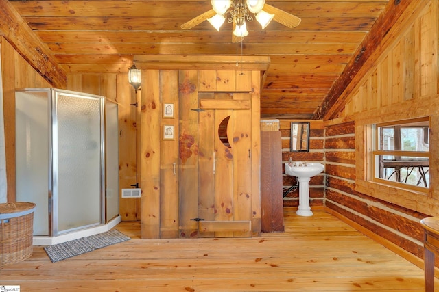 bathroom featuring wooden walls, lofted ceiling, hardwood / wood-style flooring, an enclosed shower, and wood ceiling