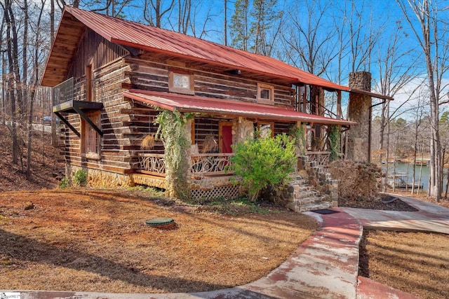 view of front facade with a porch and a water view