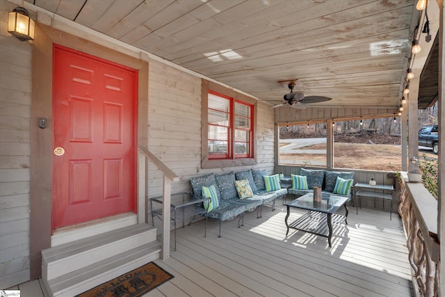 wooden deck featuring outdoor lounge area and ceiling fan