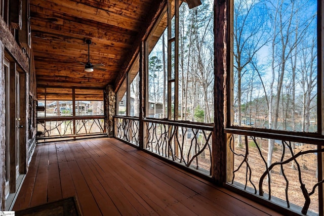 unfurnished sunroom with lofted ceiling, wooden ceiling, and ceiling fan