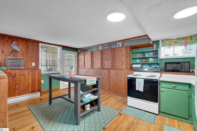 kitchen with light hardwood / wood-style flooring, a baseboard radiator, wooden walls, green cabinets, and electric stove