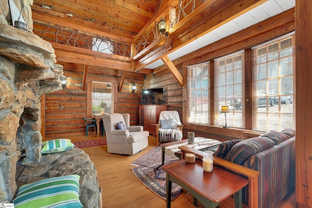 living room with wood ceiling, rustic walls, and light hardwood / wood-style flooring