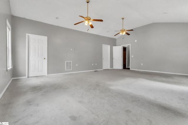 carpeted empty room with ceiling fan and high vaulted ceiling