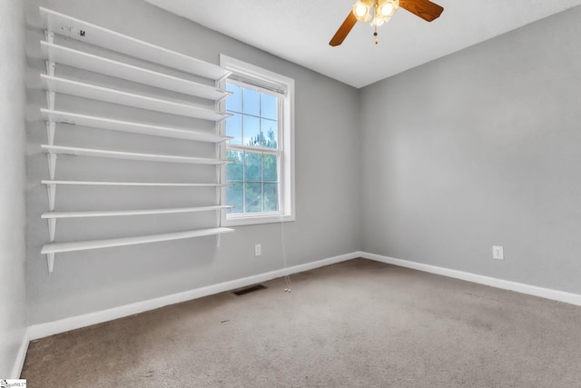 spare room featuring ceiling fan and carpet