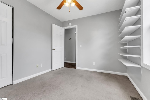 unfurnished bedroom featuring ceiling fan and carpet flooring