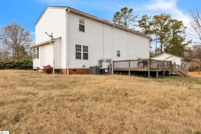 rear view of house featuring central AC and a deck